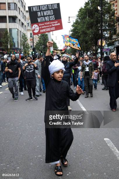 Young protester holds up a placard on Oxford Street during the annual Ashura march on October 1, 2017 in London, England. Thousands of protesters...