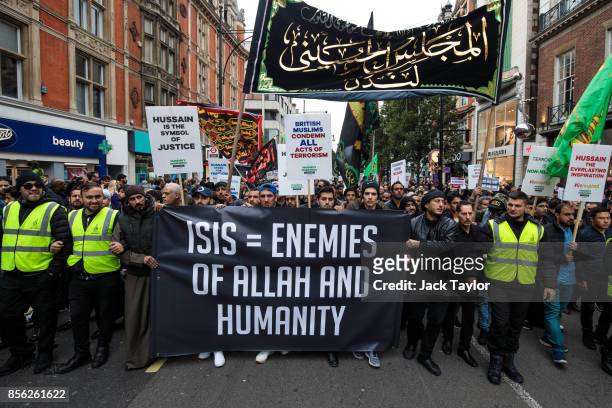 Protesters holding banners and placards demonstrate along Oxford Street during the annual Ashura march on October 1, 2017 in London, England....