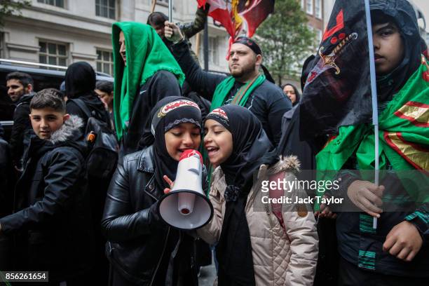 Young protesters chant into a megaphone during the annual Ashura march in Marble Arch on October 1, 2017 in London, England. Thousands of protesters...