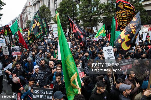 Protesters holding flags and placards demonstrate along Oxford Street during the annual Ashura march in Marble Arch on October 1, 2017 in London,...