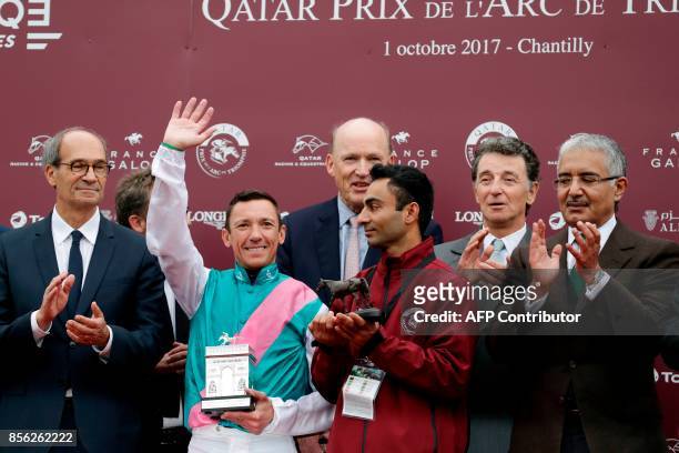Italian Jockey Lanfranco Dettori aka Frankie Dettori , flanked by head of French Parliament Finance Commission Eric Woerth , reacts as he celebrates...
