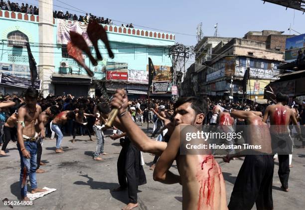 Muslim devotees take part in a mourning procession marking the day of Ashura, 10 Muharram-ul-Haram, at Shia Jama Masjid Kashmiri Gate, on October 1,...