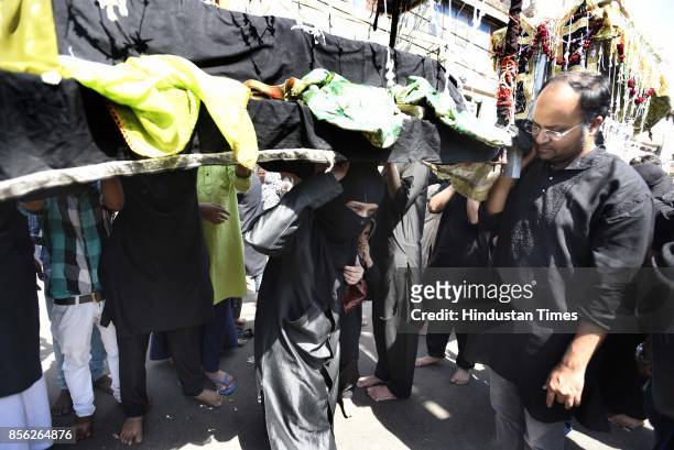Muslim devotees take part in a mourning procession marking the day of Ashura, 10 Muharram-ul-Haram, at Shia Jama Masjid Kashmiri Gate, on October 1,...