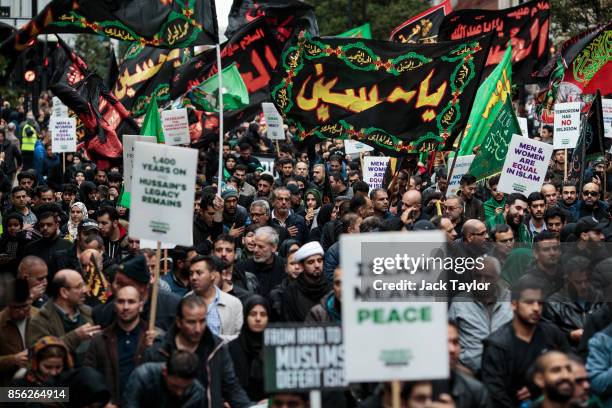 Protesters holding flags and placards demonstrate along Oxford Street during the annual Ashura march on October 1, 2017 in London, England. Thousands...