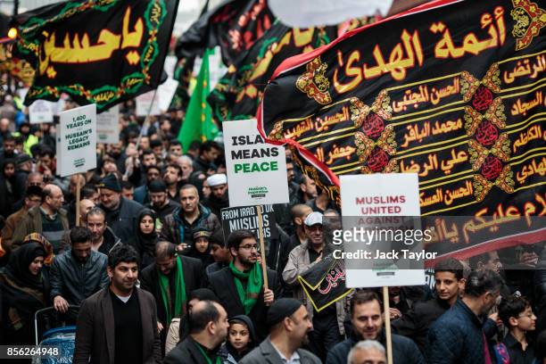 Protesters holding flags and placards demonstrate along Oxford Street during the annual Ashura march on October 1, 2017 in London, England. Thousands...
