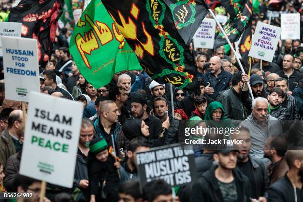 Protesters holding flags and placards demonstrate along Oxford Street during the annual Ashura march on October 1, 2017 in London, England. Thousands...