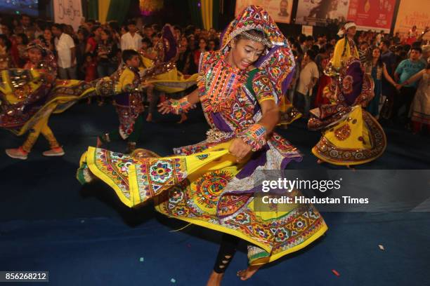 Women perform dandiya dance on the last day of "Thane Raas Rang Navratri Festival" at Modella Mill Compound Thane, on September 30, 2017 in Mumbai,...