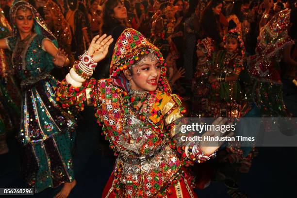 Women perform dandiya dance on the last day of "Thane Raas Rang Navratri Festival" at Modella Mill Compound Thane, on September 30, 2017 in Mumbai,...