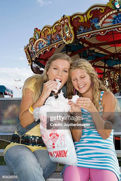 mother and daughter eating cotton candy - teenagers eating with mum stock pictures, royalty-free photos & images