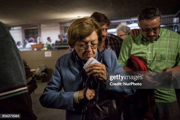 Catalan people participing to the referendum on the independence of their region, in Barcelona, Spain, on October 1, 2017. Spanish riot police fired...