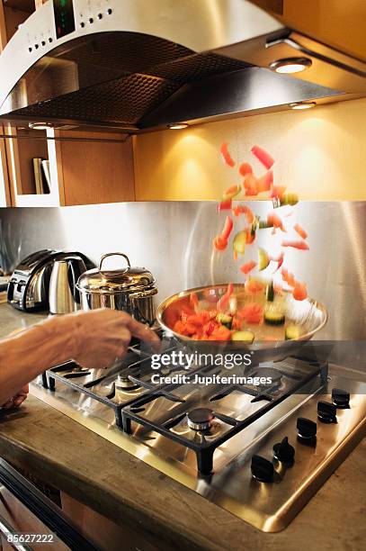 tossing stir fried vegetables - saute pan stock pictures, royalty-free photos & images