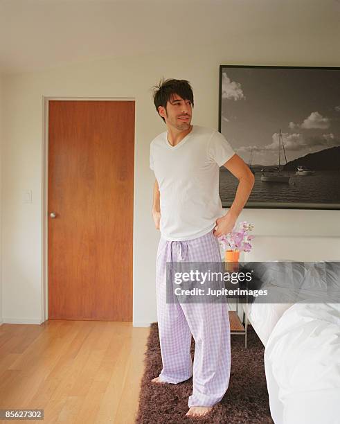 sleepy man in pajamas - pajamas stockfoto's en -beelden