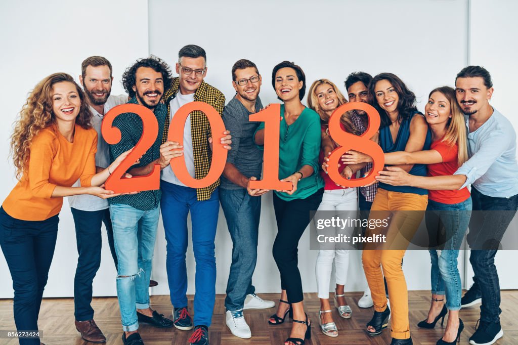 Large group of people holding 2018 numbers