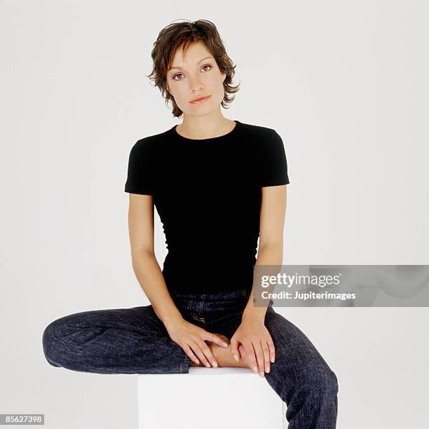 woman in jeans and black t-shirt - white/black shirt stock-fotos und bilder