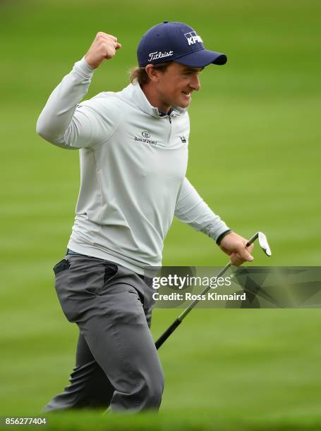 Paul Dunne of Ireland celebrates after chipping in on the 18th hole to win the tournament during day four of the British Masters at Close House Golf...