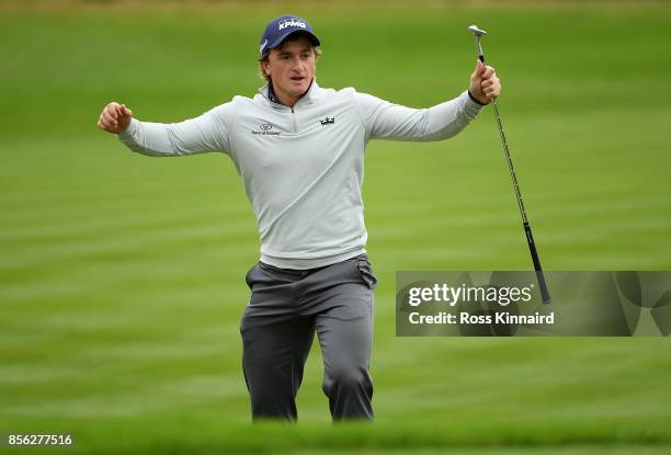 Paul Dunne of Ireland celebrates after chipping in on the 18th hole to win the tournament during day four of the British Masters at Close House Golf...