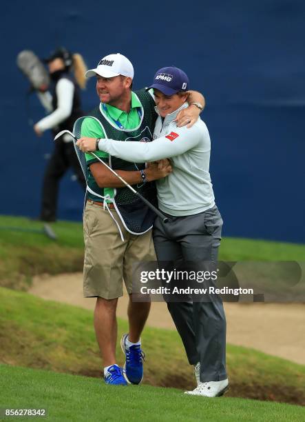 Paul Dunne of Ireland celebrates with his caddie Darren Reynolds after chipping in on the 18th hole to win the tournament during day four of the...