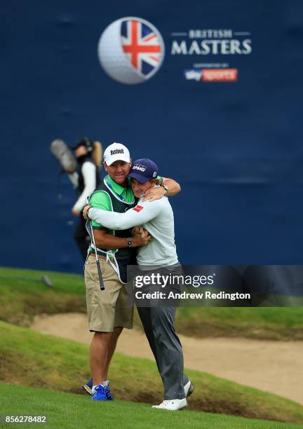 Paul Dunne of Ireland celebrates with his caddie Darren Reynolds after chipping in on the 18th hole to win the tournament during day four of the...