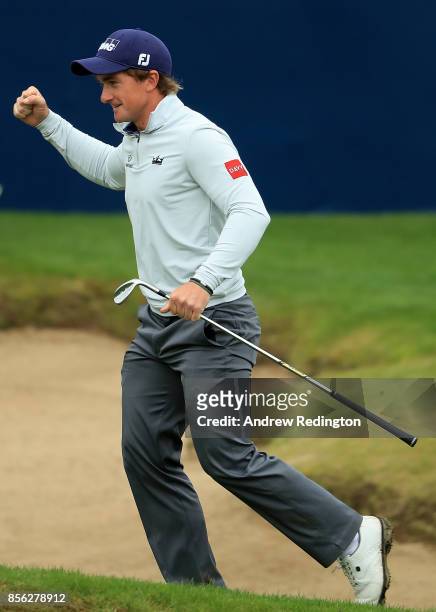 Paul Dunne of Ireland celebrates after chipping in on the 18th hole to win the tournament during day four of the British Masters at Close House Golf...
