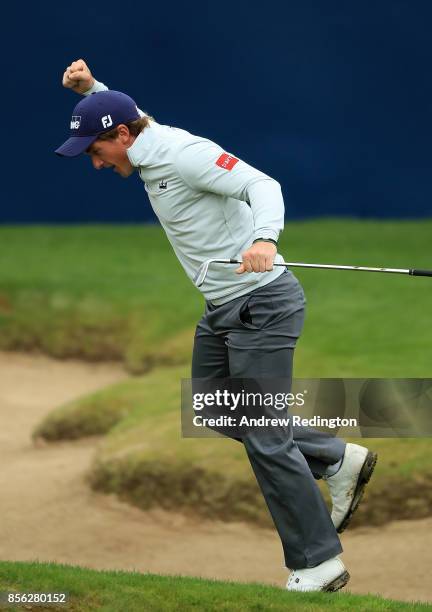 Paul Dunne of Ireland celebrates after chipping in on the 18th hole to win the tournament during day four of the British Masters at Close House Golf...