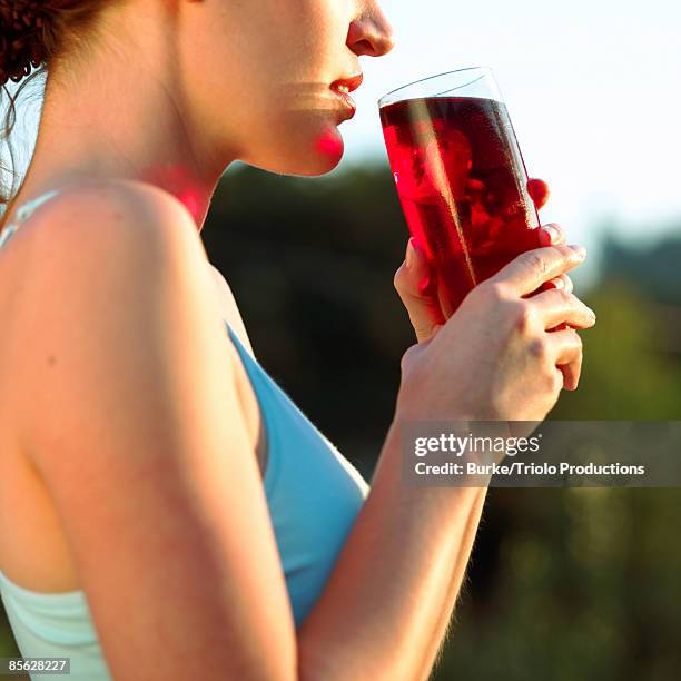 woman drinking cranberry juice - cranberry juice stock pictures, royalty-free photos & images