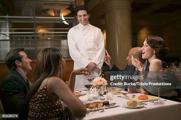 couples in restaurant talking to chef - couple fine dining stock pictures, royalty-free photos & images