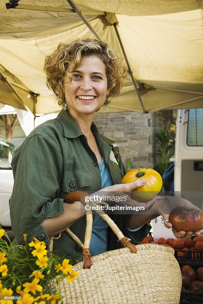 Woman with heirloom tomatoes