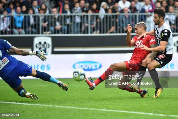 Lyon's Spanish forward Mariano Diaz vies with Angers' French defender Romain Thomas and scores against Angers' French goalkeeper Alexandre Letellier...