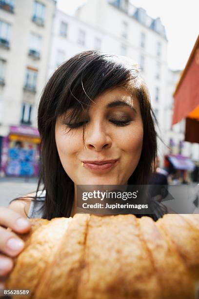 woman eating croissant - french croissant stock pictures, royalty-free photos & images