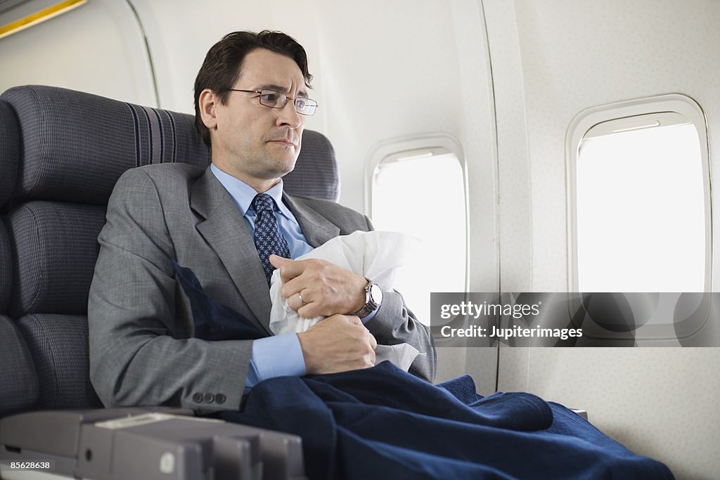 Nervous passenger sitting on airplane