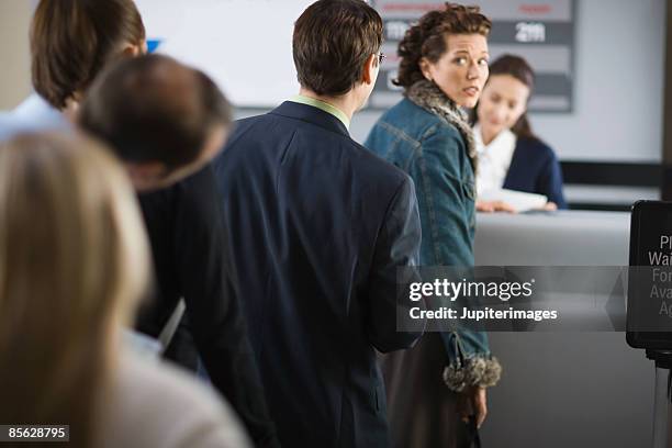 nervous passenger in line at airport - esperar na fila imagens e fotografias de stock
