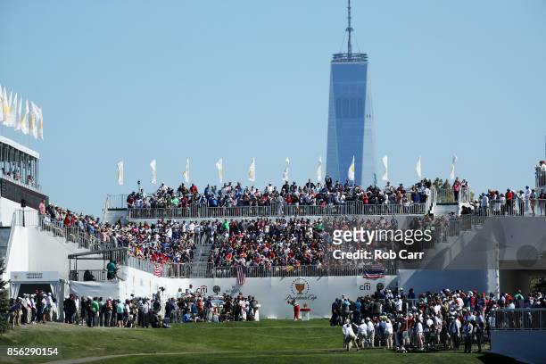 Justin Thomas of the U.S. Team plays his shot from the first tee during Sunday singles matches of the Presidents Cup at Liberty National Golf Club on...