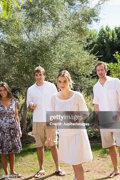 friends in line holding bocce balls - bocce ball stock pictures, royalty-free photos & images