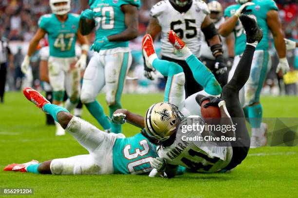 Alvin Kamara of the New Orleans Saints scores a touchdown during the NFL match between New Orleans Saints and Miami Dolphins at Wembley Stadium on...