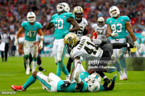 Alvin Kamara of the New Orleans Saints scores a touchdown during the NFL match between New Orleans Saints and Miami Dolphins at Wembley Stadium on...