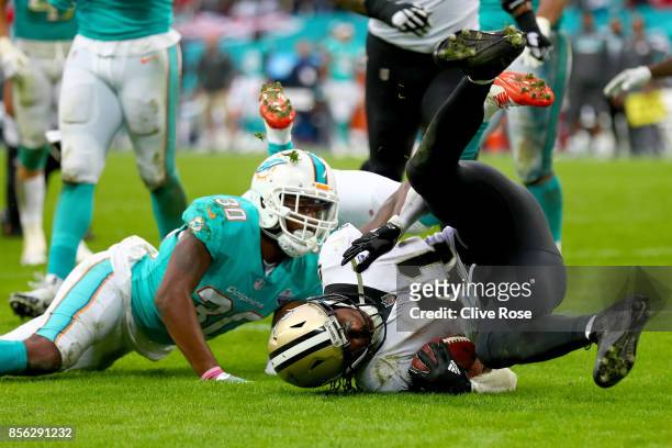 Alvin Kamara of the New Orleans Saints scores a touchdown during the NFL match between New Orleans Saints and Miami Dolphins at Wembley Stadium on...