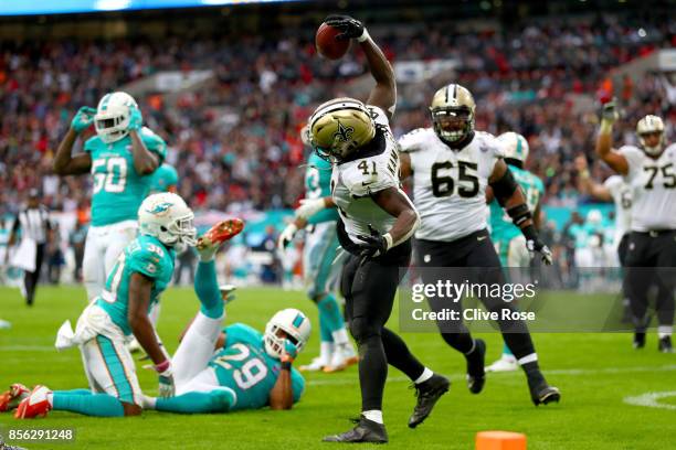 Alvin Kamara of the New Orleans Saints celebrates his touchdown during the NFL match between New Orleans Saints and Miami Dolphins at Wembley Stadium...