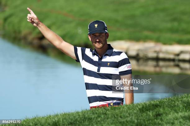 Kevin Chappell of the U.S. Team celebrates after playing from the bunker for eagle on the second hole to go one up over Marc Leishman of Australia...