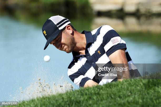 Kevin Chappell of the U.S. Team plays a shot from the bunker for eagle on the second hole to go one up over Marc Leishman of Australia and the...