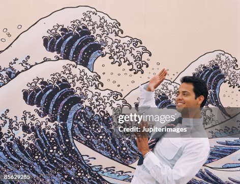 Man avoiding ocean waves on wall mural Man avoiding ocean waves on wall mural