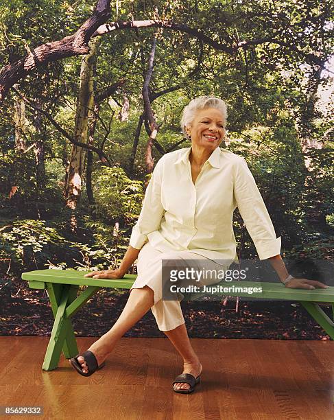 portrait of woman sitting on bench - mural portrait stock pictures, royalty-free photos & images