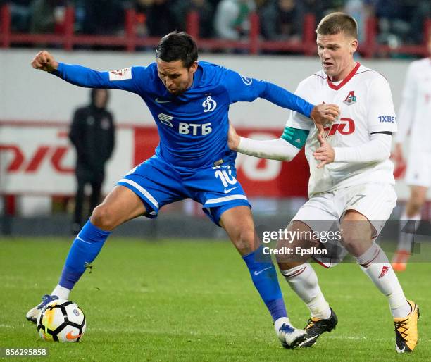 Igor Denisov of FC Lokomotiv Moscow vies for the ball with Alexander Zotov of FC Dinamo Moscow during the Russian Premier League match between FC...