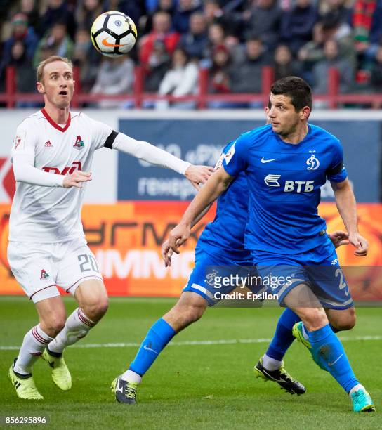 Vladislav Ignatyev of FC Lokomotiv Moscow vies for the ball with Fatos Beciraj of FC Dinamo Moscow during the Russian Premier League match between FC...