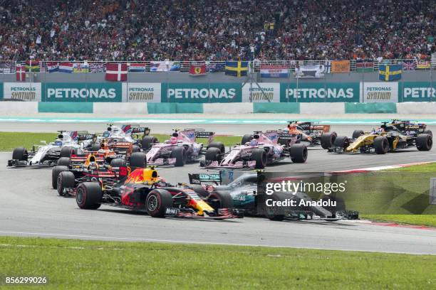 Cars compete in the F1 Grand Prix at the Sepang F1 circuit outside Kuala Lumpur, Malaysia on October 01, 2017. Verstappen won the race and Ricciardo...