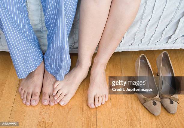 man and woman playing footsie - playing footsie stock-fotos und bilder