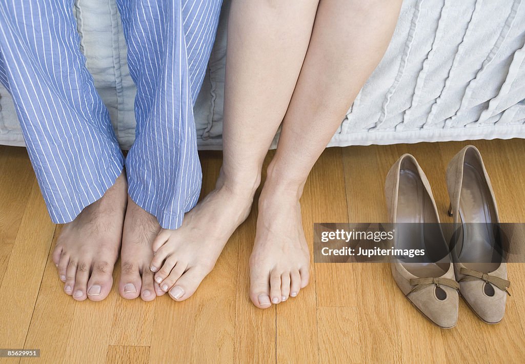 Man and woman playing footsie