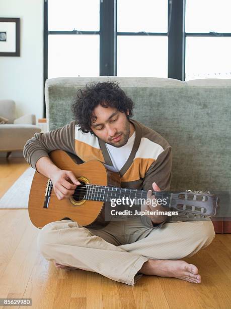 man playing guitar - barefoot stock pictures, royalty-free photos & images