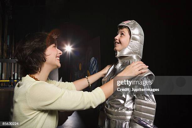 woman with child wearing astronaut costume - theater costume - fotografias e filmes do acervo
