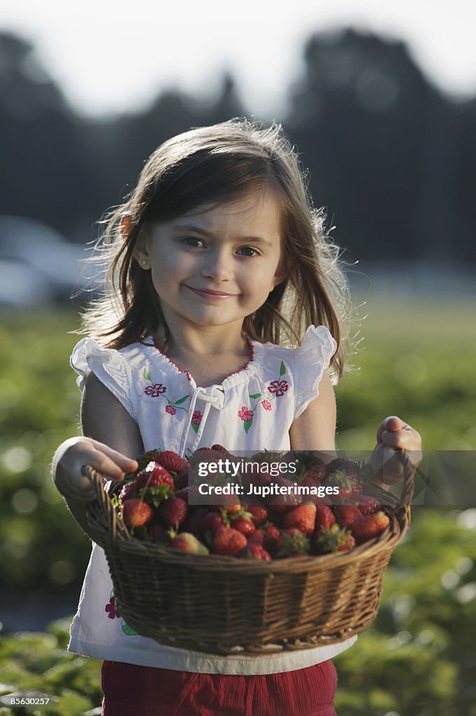 Girl with basket of strawberries