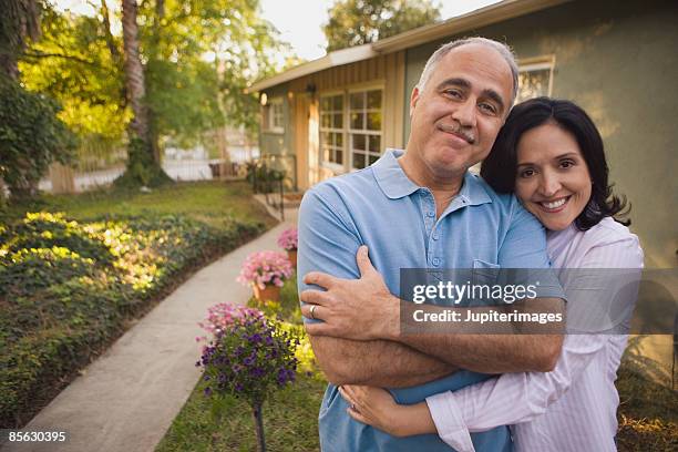 portrait of smiling couple - hispanic couple stock-fotos und bilder